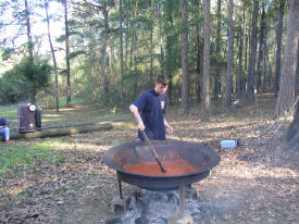 Benjamin Crowley stirring the chili pot.
