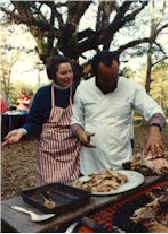 Margaret & Major carve the barbecued pig